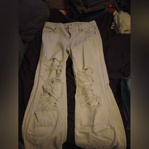 Cream colored low waisted flared jeans